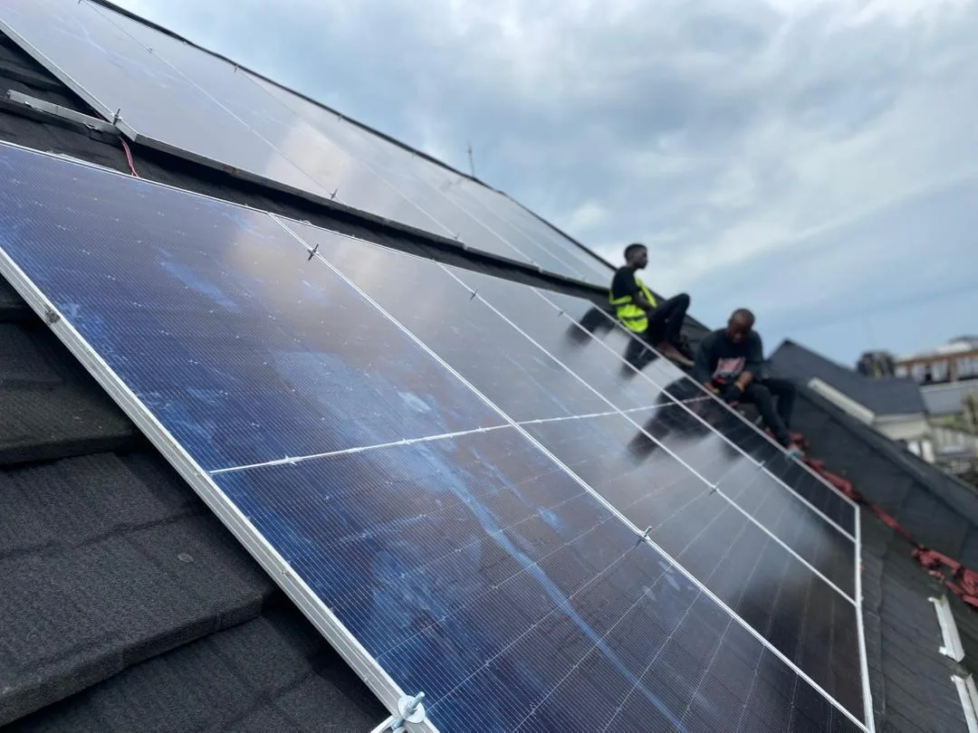 Crew finishing a rooftop solar array